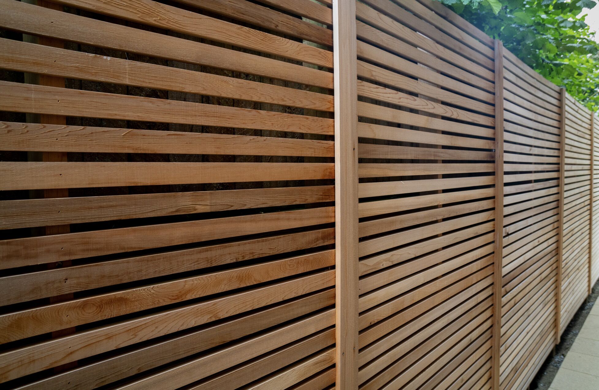 Modern horizontal wood fence with clean lines for residential backyard